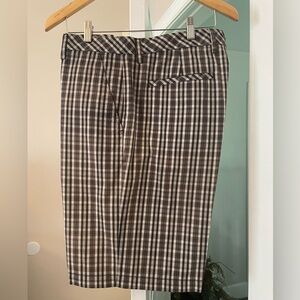 Ashworth Men’s Golf Shorts. Waist size is 35”. Black background with a pattern.